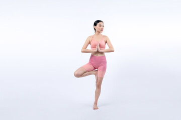 Asian woman in sportswear doing yoga exercise in standing pose on fitness as her workout training routine. Healthy body care and meditation yoga lifestyle in full shot on isolated background. Vigorous