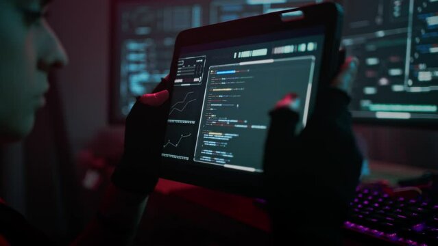 Woman hacker examining functionality of software on tablet