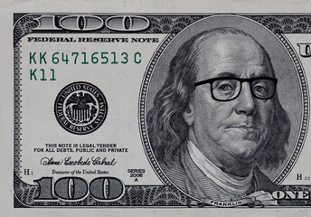 Benjamin Franklin in glasses on US 100 dollar banknote