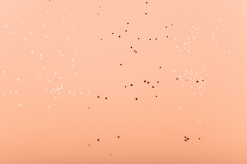 Trendy pink background with gold sequins and stars