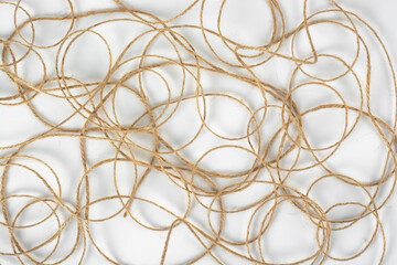 Piece of jute twine on white background. Natural rope for packaging and decoration. Coarse linen threads. Hemp twine.