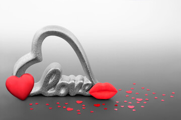 Heart shape love sign, luscious red pouting lips and loose red heart confetti decorations on...