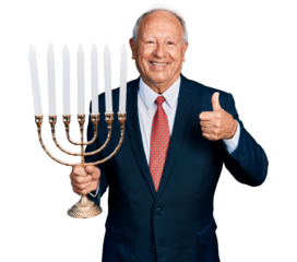 Senior business man with grey hair holding menorah hanukkah jewish candle smiling happy and positive, thumb up doing excellent and approval sign
