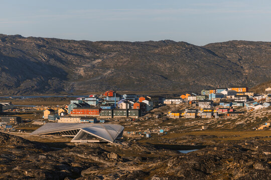 View of Ilulissat Isfjordscenter museum at golden morning light in front of cityscape, Ilulissat, Greenland.