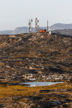 View of cemetery and radio tower at golden light in Ilulissat, Greenland.
