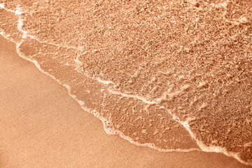Sea foam with golden sand. Concept of spending vacation in paradise. Demonstrating color of 2024...
