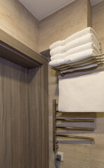 A stack of clean white towels in the shower room