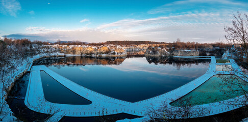 Krakow, Poland - November 30, 2023: Swimming and paddling pools on a Zakrzowek lake with steep cliffs in place of former flooded limestone quarry. Panoramic view at winter time