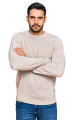 Fototapeta premium Young hispanic man wearing casual clothes skeptic and nervous, disapproving expression on face with crossed arms. negative person.