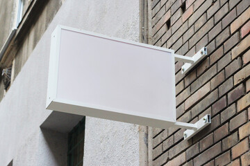 Street storefront shop, cafe, restaurant mounted signboard mock up design template. Blank white store sign design mockup.