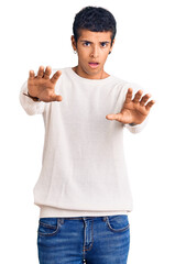 Fototapeta premium Young african amercian man wearing casual clothes doing stop gesture with hands palms, angry and frustration expression