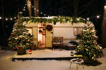 Mobile home Caravan with terrace at night, Mobile home decorated with Christmas decor. Festive...