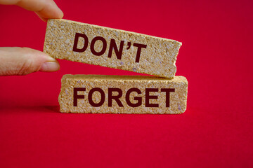 Do not forget symbol. Concept word Don't forget on brick blocks. Beautiful red background....