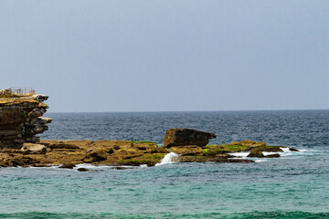 Waves crashing on the rocks by Bondi beach