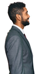 Young african american man wearing business clothes looking to side, relax profile pose with...