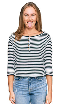 Beautiful blonde woman wearing casual clothes sticking tongue out happy with funny expression. emotion concept.