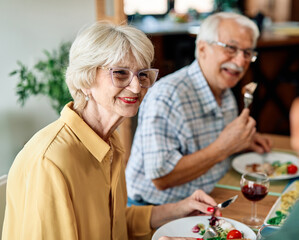 senior mature elderly couple active family lunch food woman meal eating mother dinner father...