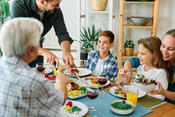 child family lunch food woman meal eating mother dinner man father together happy daughter home table dining parent grandparent