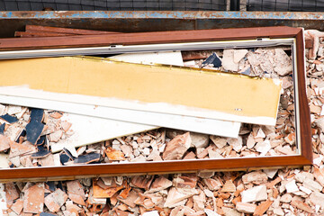 debris deposited by construction workers in rubble dumpster container in street city
