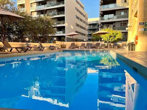 view of a swimming pool in a malta hotel on a sunny summer day
