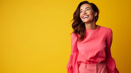 Foto op Plexiglas A joyful ultra beauty businesswoman, representing confidence, wearing a bright pink dress against a vibrant yellow background, smiling radiantly. © Creative artist1
