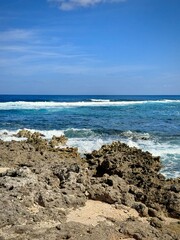 Fototapeta na wymiar Caribbean seascape with a view of a rocky coast and the Caribbean Sea with waves crashing on rocks 
