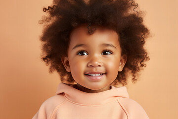macro shot close up detail of a black toddler girl in peach fuzz color sweatshirt  on a pastel...