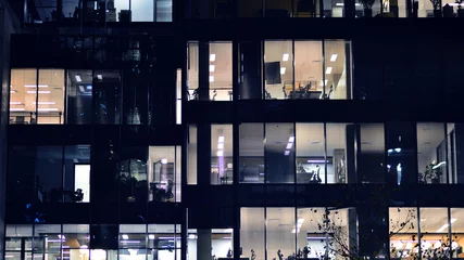  Fragment of the glass facade of a modern corporate building at night. Modern glass office  in city.  © Grand Warszawski