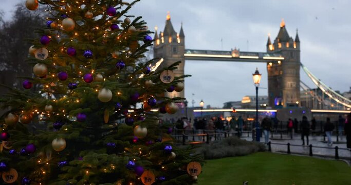 Winter view of a festive decorated Christmas Tree in front of the iconic Tower Bridge of London, England