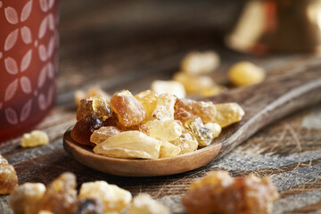 Frankincense resin on a spoon on a table, close up