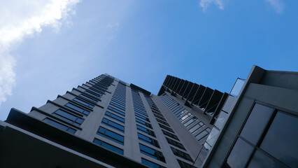 Close-up bottom view of office building, hotel, condominium, apartment window. with clouds in the...
