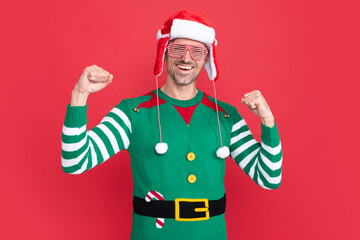 positive shouting man in elf costume and party glasses. xmas guy in santa claus hat