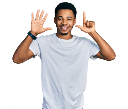 Young african american man wearing casual white t shirt showing and pointing up with fingers number seven while smiling confident and happy.
