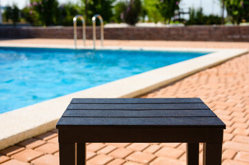 Empty table near the pool at the hotel. Free space at the resort pool. Selective focus