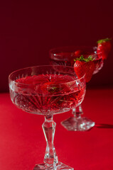 Two glasses of rose sparkling wine on red background romantic valentine's day concept