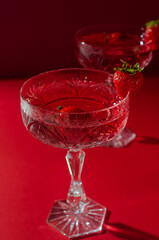 Two glasses of rose sparkling wine on red background romantic valentine's day concept