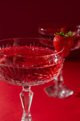 Two glasses of rose sparkling wine on red background romantic valentine's day concept