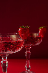 Two glasses of rose sparkling wine on red background romantic valentine's day concept