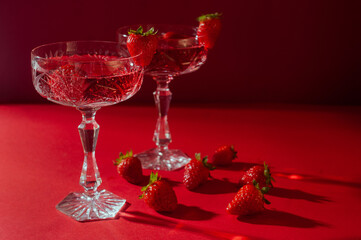 Two glasses of rose sparkling wine on red background romantic valentine's day concept
