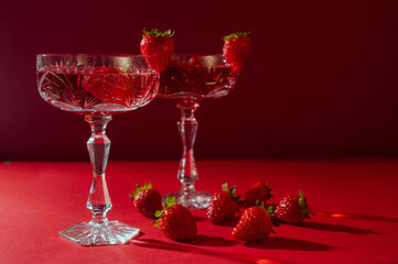 Two glasses of rose sparkling wine on red background romantic valentine's day concept