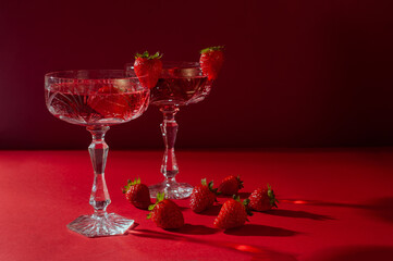 Two glasses of rose sparkling wine on red background romantic valentine's day concept