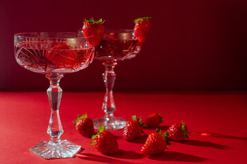 Two glasses of rose sparkling wine on red background romantic valentine's day concept