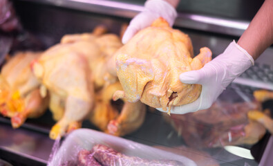 Inside refrigerated display, selection of poultry products is neatly presented.