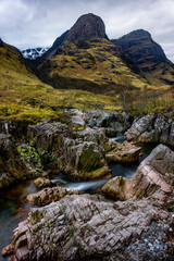 Beautiful waterfall and rapids with the Three Sisters Mountains in Glencoe, the Scottish Highlands, Scotland UK