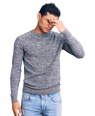 Hispanic handsome young man wearing casual sweater tired rubbing nose and eyes feeling fatigue and headache. stress and frustration concept.