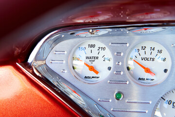 Control panel of a classic car from the 40's or 50's. Silver with red borders. Gas, speed, water. - obrazy, fototapety, plakaty