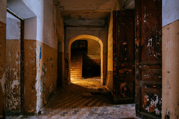 Fototapeta na wymiar Dark vaulted corridor in old abandoned building