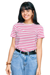 Obraz premium Young hispanic girl wearing casual clothes winking looking at the camera with sexy expression, cheerful and happy face.