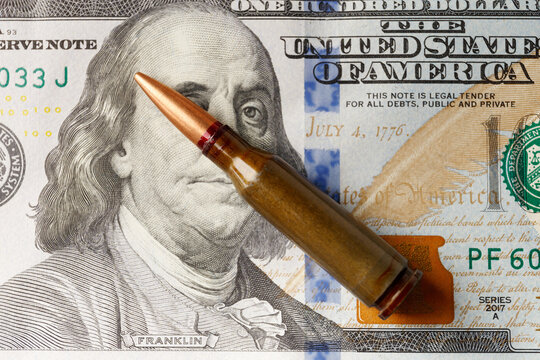 Bullets lie on American dollar bills, arms trade