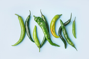 Green chili peppers on blue background